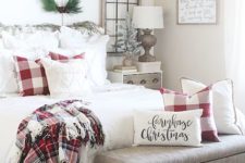 23 a traditional Christmas bedroom with plaids, whites and a deer artwork, some cool pillows