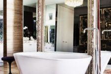 24 a mirror wall and an oversized refined vintage mirror over it to create a sophisticated space