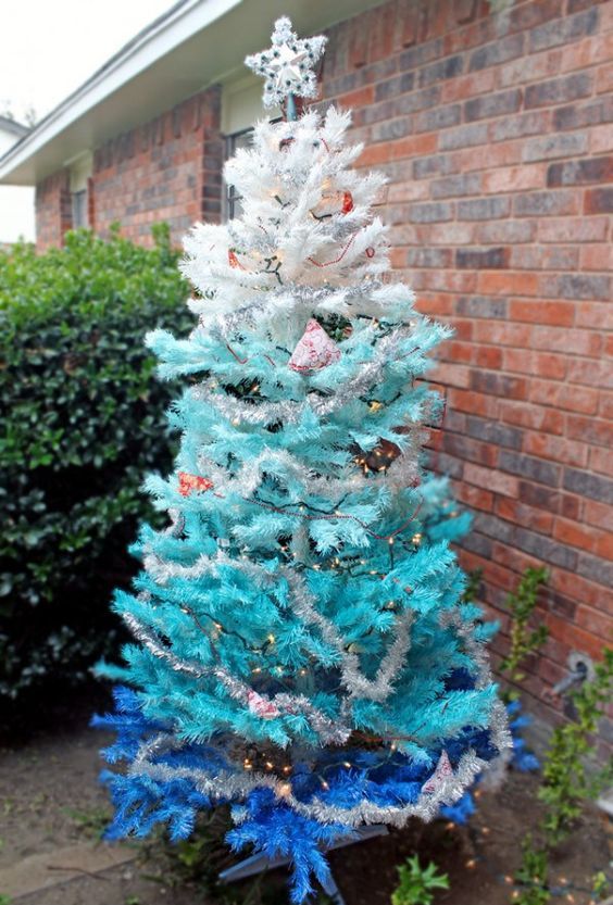 an ombre outdoor Christmas tree from white to light blue and bold blue with lights and some decor can be easily DIYed