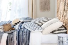 24 lots of printed textiles, wicker baskets, lamps, a headboard and a hanging make the bedroom Mediterranean at once