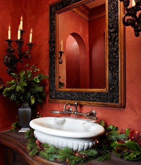 simply wrap your sink with evergreens with lights and add an evergreen arrangement for holiday cheer