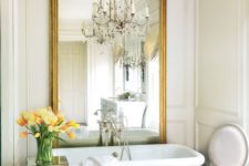 25 a large vintage frame mirror accents the free-standing bathtub and brings exquisite vibes to the space
