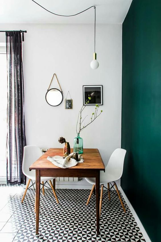 a statement emerald wall adds color to the space and can be changed and repainted anytime