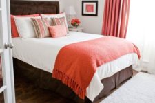 25 coral curtains, a coral throw and pillows add a trendy colorful touch to the bedroom and make it cheerful