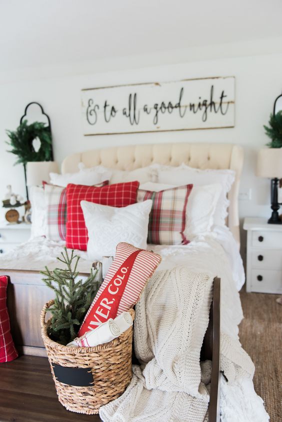 make your bedroom cozier with farmhouse decor, evergreen wreaths, a basket with a Christmas tree, plaid pillows and a large sign
