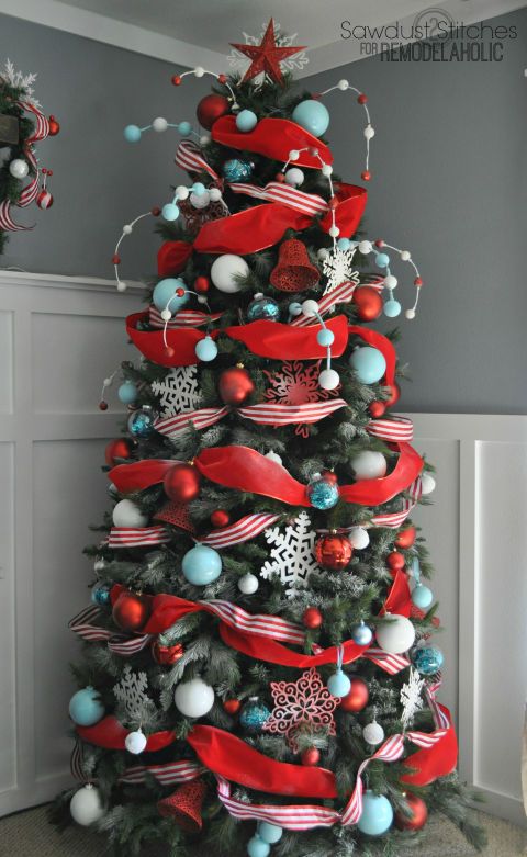 a colorful Christmas tree done in turquoise and red, with white and silver ornaments and beads plus a star on top