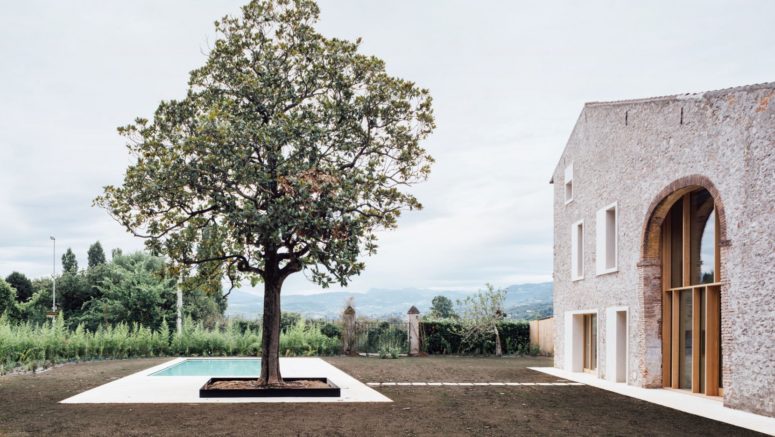 This contemporary family home is a converted stone barn in Italy, and it shows many sustainable features