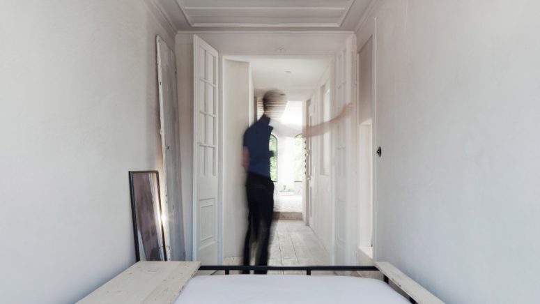 The apartment is done in neutrals, there's much natural light and air, and those original frescoes and other touches give a character to the space