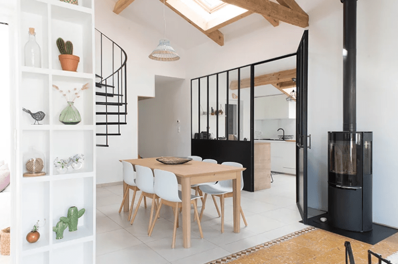 The interior is done in white and neutrals mostly, there are black touches for drama, and lots of windows and skylights to fill the home with light