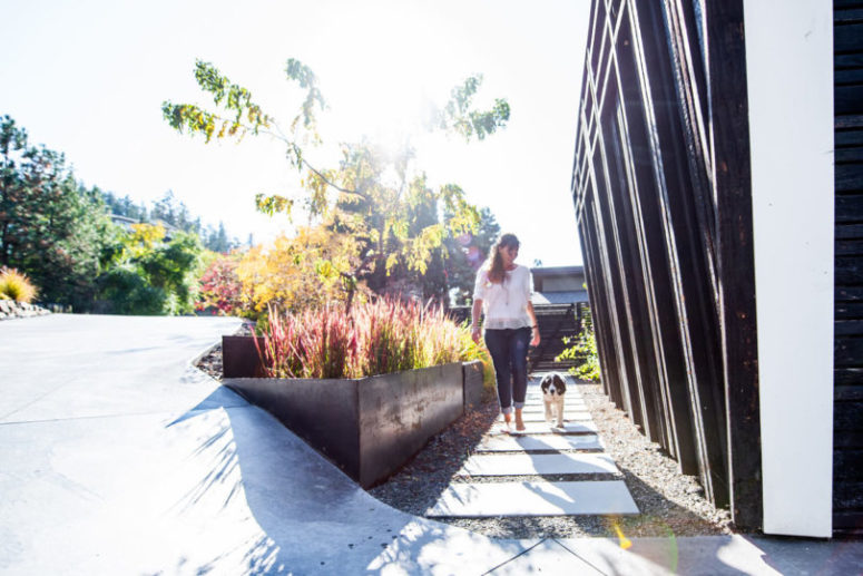 You may see perfectly styled landscaping, gravel and tile pathways and bold grasses to acaent the house