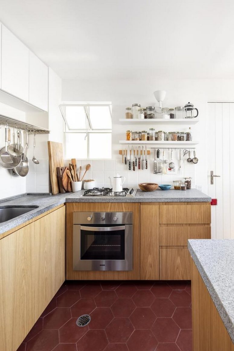 wooden kitchen with gorgeous minimalist concrete countertops The kitchen is done with white and wooden cabinets, with concrete countertops and a white tile backsplash