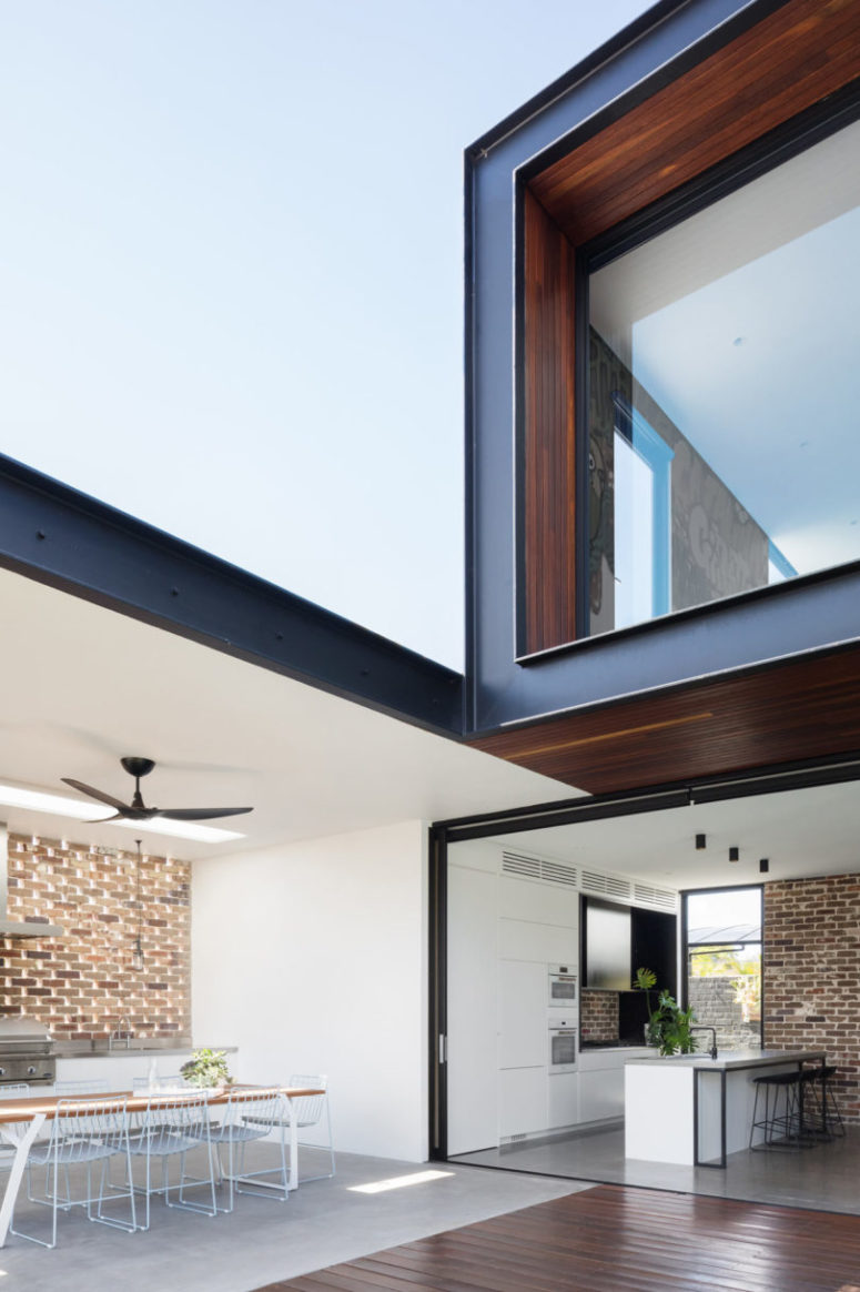The main open layout is connected to outdoors, an outdoor kitchen and dining space