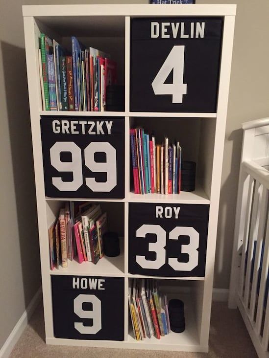 a cool boys' room storage piece with black Drona boxes labeled in the sport theme