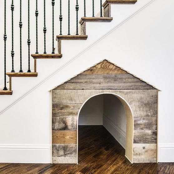 build in a dog house under the staircase to give him or her a personal space while being around you at the same time