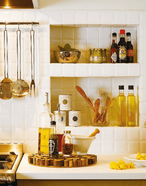 Niches in the backsplash are great for storing spices and herbs