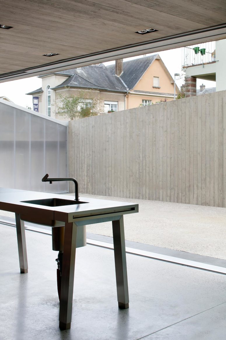 The kitchen island is minimalist and stripped down to minimal