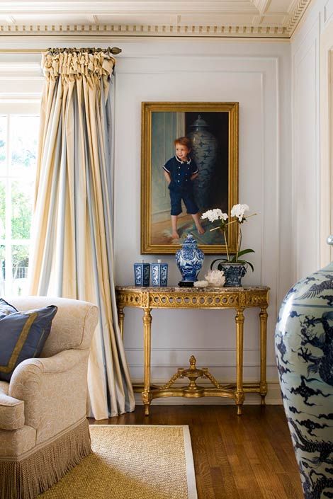 striped curtains add to the living room and highlight its color scheme, blue and yellow