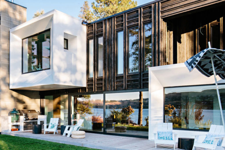 Another house side features severla sitting zones, an outdoor kitchen and the facade is mostly glazed to catch the lake views