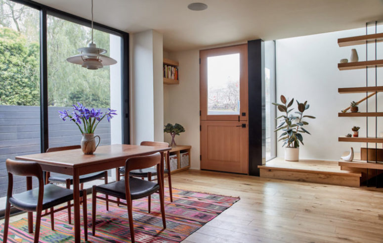 The dining space is done with a table and comfy chairs, plus a tribal rug, there's much natural light here