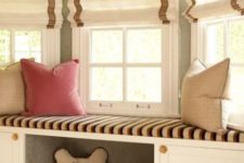 05 an upholstered windowsill bench with some built-in storage and a comfy pet niche with toys
