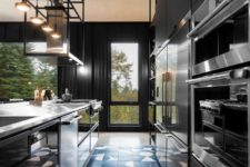 06 A moody kitchen is done with black sleek cabinets, a mosaic tile floor in black and white