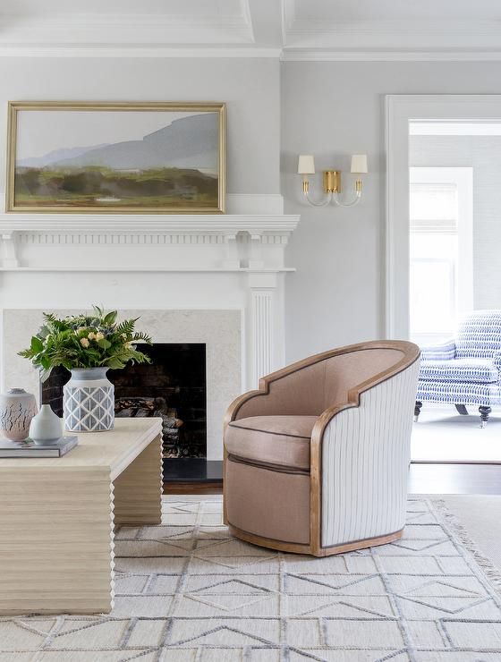 a cute and delicate dusty pink curved chair with touches of wood for a touch of chic