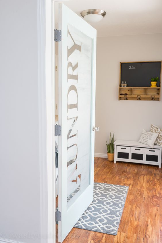 a frosted glass laundry door with letters is a cool and fresh idea to try for a modern home