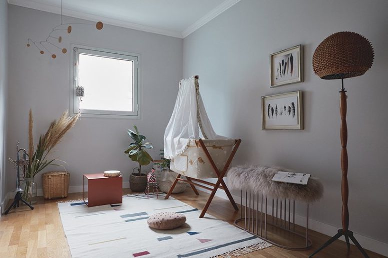 The nursery is done with a cool crib, a fur bench, some printed textiles and potted plants