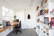 09 A home office is done with a large storage unit and a floating desk by the window, potted greenery refreshes the space