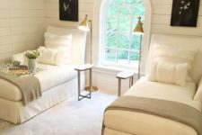 10 a cozy vintage-inspired guest bedroom with two beds, brass lamps and an arched window
