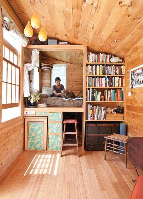 a podium bed with drawers for storage under it and some space to hide furniture there
