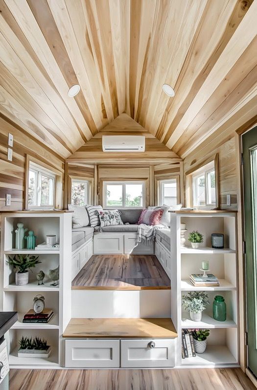 a cool U-shaped daybed with storage under it and some shelving units next to it