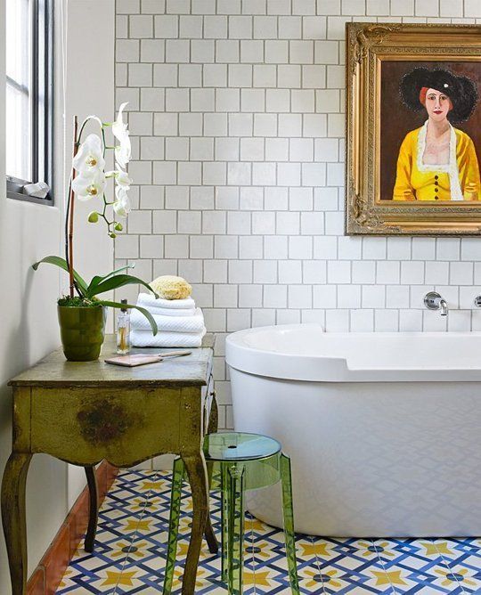 bold blue and yellow mosaic tiles on the floor set the tone in the bathroom, and white tiles on the wall just calm them down