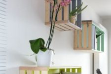 16 Knagglig boxes painted in bright colors inside and attached to the wall as open storage items