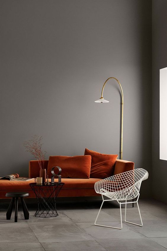 a rust velvet sofa in a moody space is a refined and chic item to rock