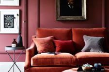 16 create a color block effect with burgundy walls and rust-colored velvet furniture