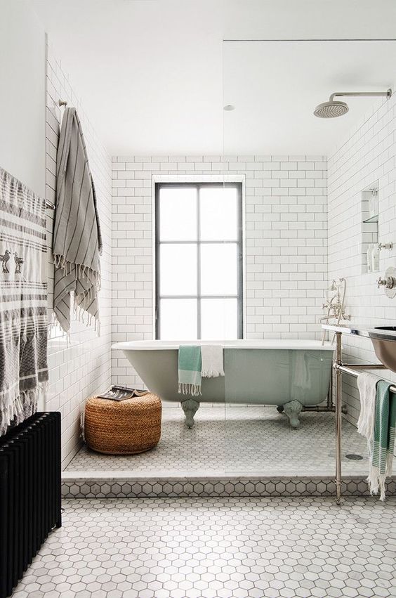 grey marble hex tiles on the floor are a refined and stylish accent, and white subway tiles on the walls are a cool backdrop