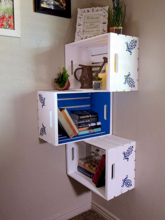 a corner shelf unit made of Knagglig boxes painted inside and stenciled outside and attached to each other