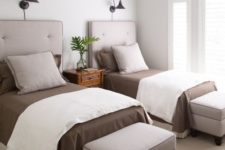 20 a stylish modern guest bedroom with two beds, storag eottomans and some wall lamps