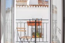 21 a small balcony with a couple of chairs and a little table allow eating and havign drinks outside