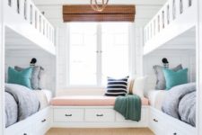22 a cozy beach-inspired guest bedroom with two bunk beds and a windowsill daybed