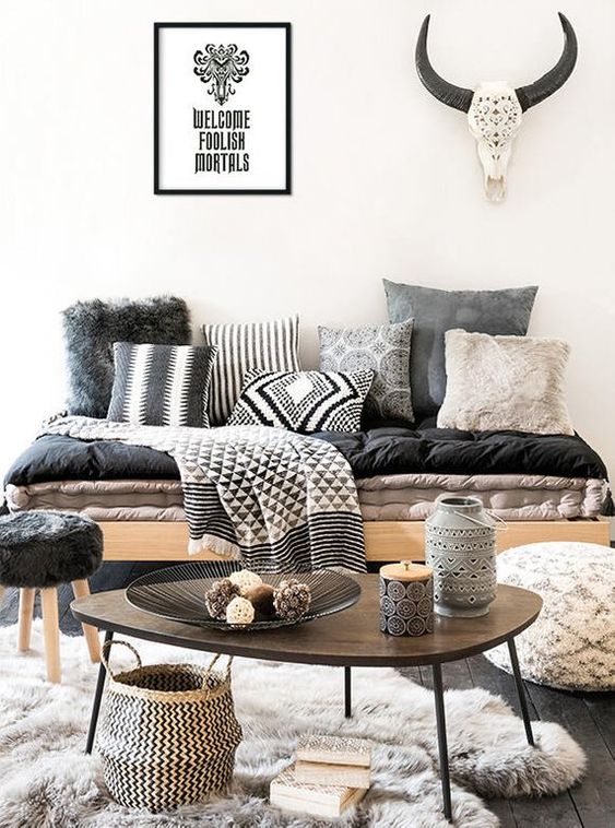 a tribal blanket and some tribal pillows bring in cool vibes making the space bolder