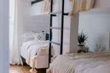 23 a cozy guest bedroom with two bunk beds and a ladder, with much natural light and pompom blankets