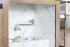 23 a kitchen island with an integrated pet food station done with marble contact paper is a stylish idea