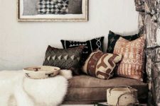23 tribal printed pillows and a tribal basket and an artwork bring a wild feel to the space