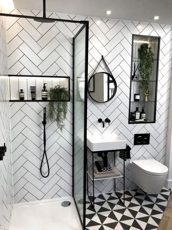 a small contemporary bathroom with herringbone clad tile walls, a printed floor, a small sink and a shower with a glass divider