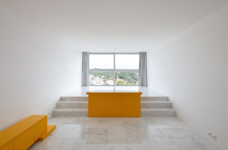 The apartment features an arrangement of basic architectural elements in bold yellow, and the space is created around them The apartment features an arrangement of basic architectural elements in bold yellow, and the space is created around them