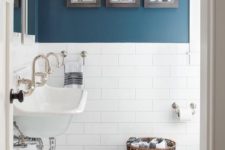 02 a contemporary bathroom with walls partly painted blue and partly clad with white tiles