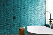 02 a turquoise fish scale tile statement wall makes the space feel mermaid-like, and a serene tub adds to it