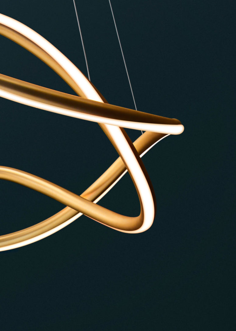 The lighting is suspended to the ceiling with thin steel ropes that also provide power